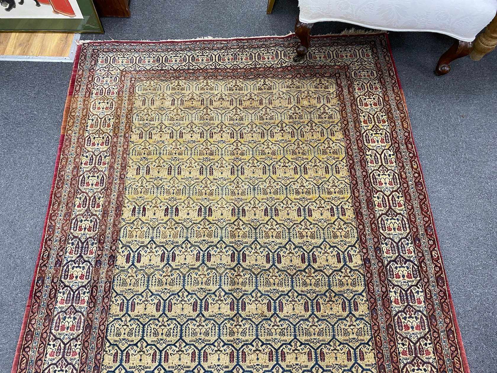 An antique North West Persian faded peach ground rug, 200 x 148cm